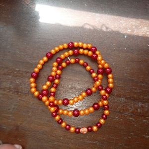 Three handmade beaded bracelets.